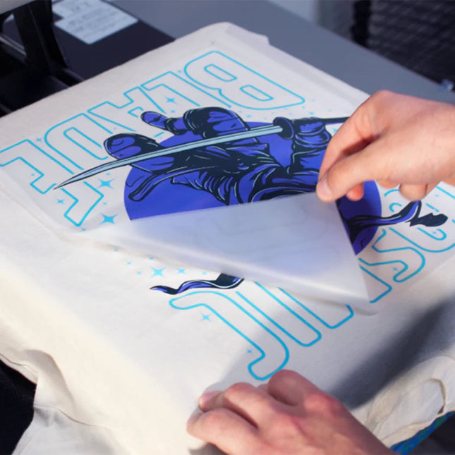 <img src="your-image-file.png" alt="A custom DTF heat transfer being hot peeled after heat pressing, revealing vibrant, high-quality designs, ideal for creating custom apparel." />
